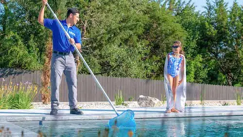 An Ultra Pool Care Squad technician netting a pool
